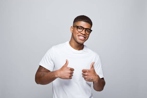 istock Cheerful young man standing with thumbs up 1378991860