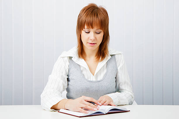 istock Attractive girl with a notepad and pen 137899576