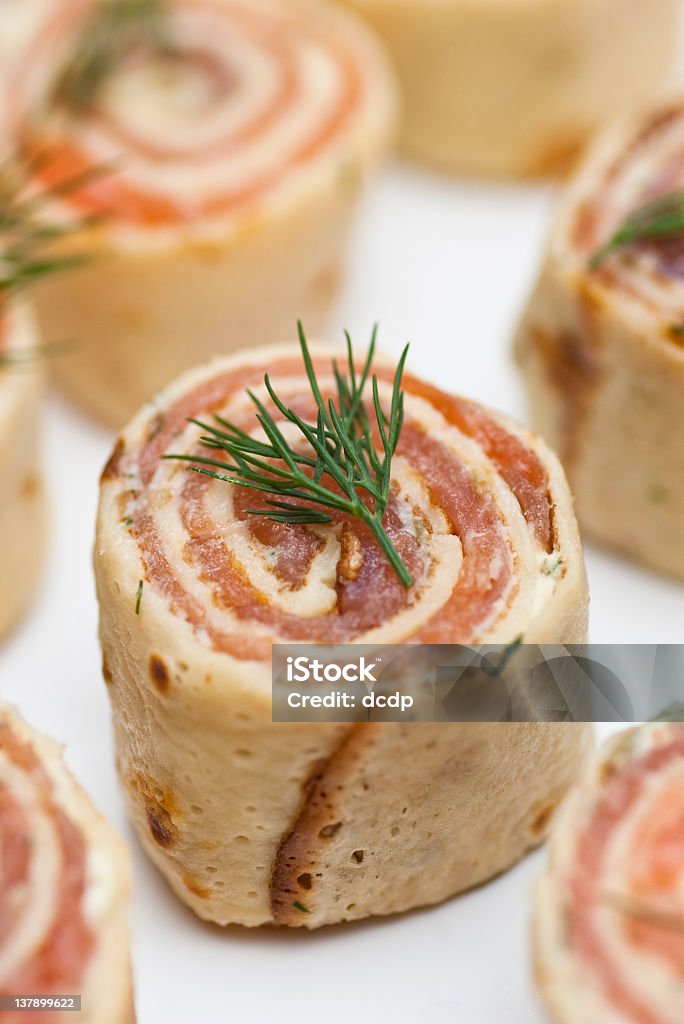 Smoked salmon roulade canape A smoked salmon roulade with a sprig of dill. A delicious spiral of fresh smoked salmon, mascarpone, capers, garlic, grated lemon rind and dill all rolled up in a delicious savory pancake. A delicious canape Salmon - Seafood Stock Photo