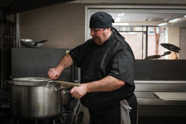 istock Master chef and cooks preparing food in a restaurant 1378996817
