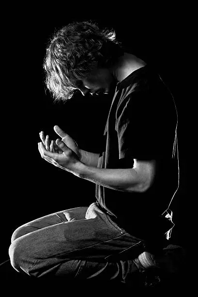 Photo of Teenager prays with cupped hands