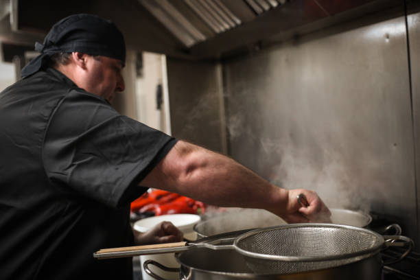 istock Master chef and cooks preparing food in a restaurant 1378998233