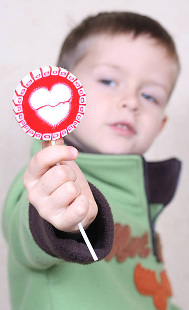 愛を込めて - child valentines day candy eating ストックフォトと画像