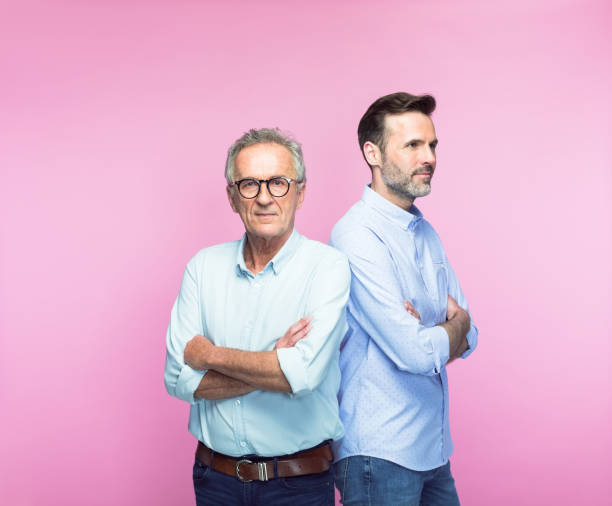 istock Confident senior man with arms crossed by son 1379030152