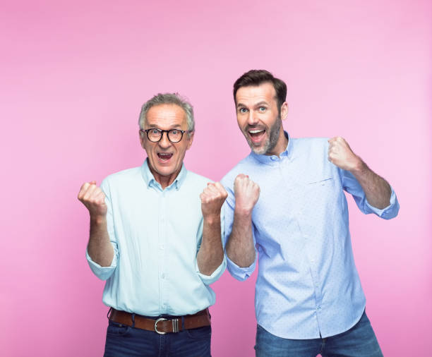 istock Excited father and son gesturing with fists 1379031162