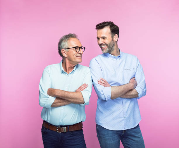 istock Happy father and son standing with arms crossed 1379032718