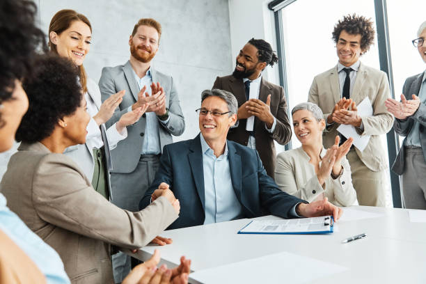istock young business people meeting office handshake hand shake shaking hands teamwork group contract signing agreement document signature paperwork success corporate senior mature happy smiling cheerful 1379040576