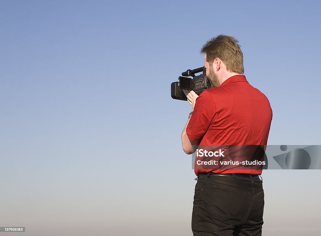 Videographer shooting footage Videographer shooting handheld footage with prosumer camcorder Adult Stock Photo
