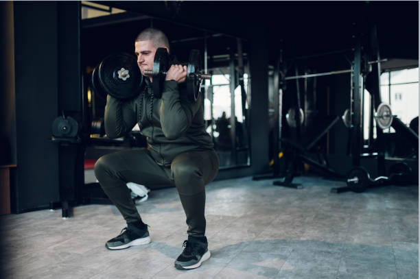 istock Man training in the gym and using dumbbells 1379066910