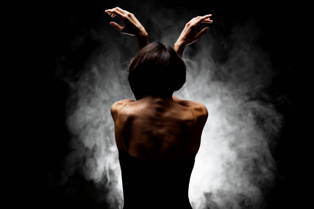 istock half silhouette modern ballet dancer posing on dark background with smoke 1379068025