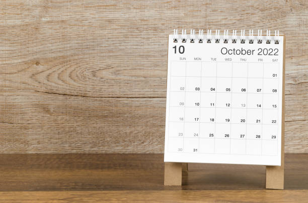 istock October 2022 desk calendar on wooden background. 1379071749