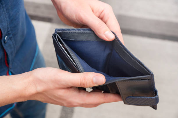 istock Empty wallet held in hands. Lack of money, poverty 1379074984