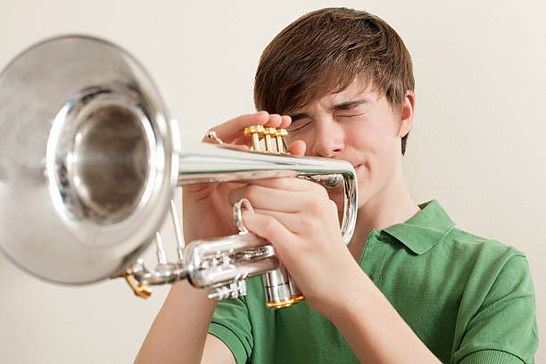 istock Teen playing silver trumpet 137908645