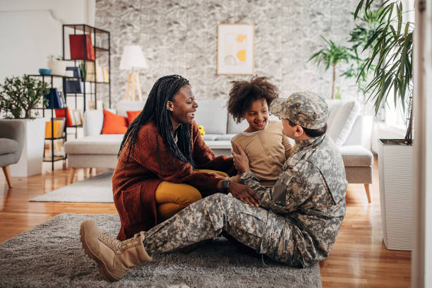 Military soldier arrived home to his family after the war Military soldier arrived home to his family after serving his country in the war unusual couple stock pictures, royalty-free photos & images