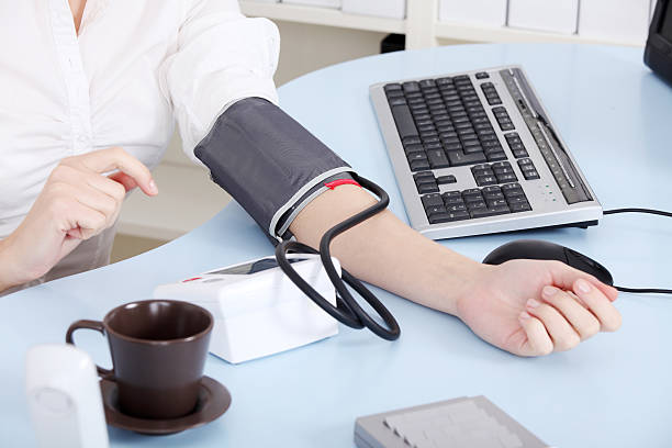 Business woman checking her blood pressure stock photo