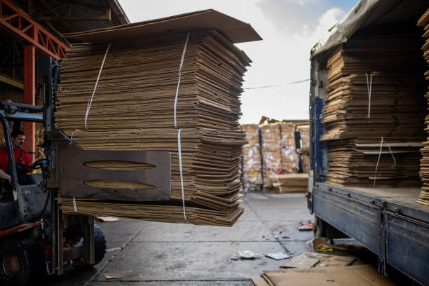 Stockholm, Sweden - Large bundles of branded cardboard boxes, crushed and compacted for recycling collection.