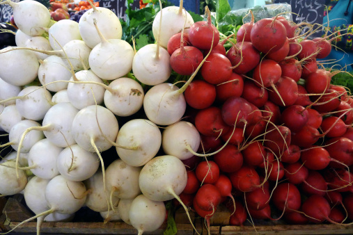 composition of white turnips and red radishes at the market