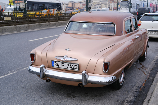 Istanbul, Turkey - February 26, 2022 : Rear view of a vintage but in good condition Studebaker, which is an American Classic Car was parked on The Galata Bridge in Istanbul.