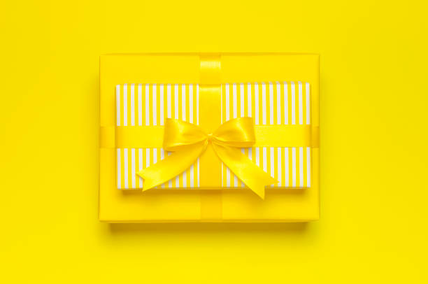 istock Flat lay holiday background. Two Bright yellow gift present box with ribbon and bow on yellow background top view copy space. Birthday present, March 8, Mother's Day, Valentine's Day. Congratulation 1379141721
