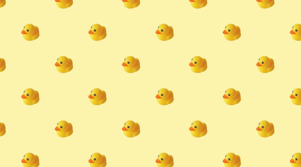 istock pattern of yellow rubber ducks on a yellow background 1379141744