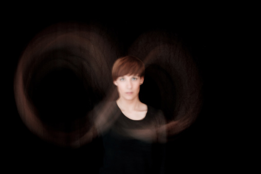 Abstract young woman portrait with long exposure infinity symbol