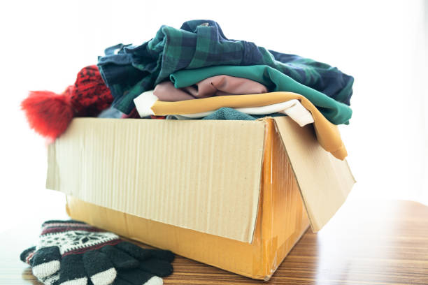 istock Donation box with used clothes at home to support help for poor people in the world. 1379149658