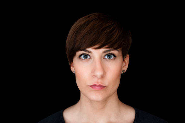 Dark silhouette of a young woman on a white background, front view, the concept of anonymity