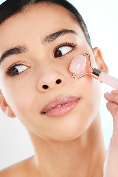 istock Studio shot of an attractive young woman using a face massager against a light background 1379150826