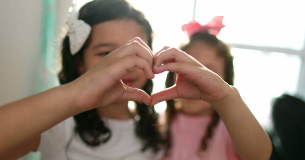 istock Children doing heart symbol with hands together close-up 1379155758