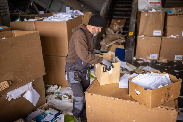 istock Caucasian male worker separates the material for recycling 1379161755