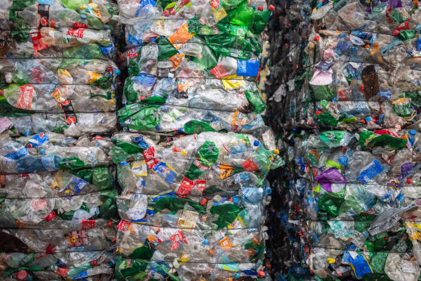 Flattened plastic bottles are collected and packed in bales for recycling At the recycling center, plastic bottles are collected and packed for recycling recycling center stock pictures, royalty-free photos & images