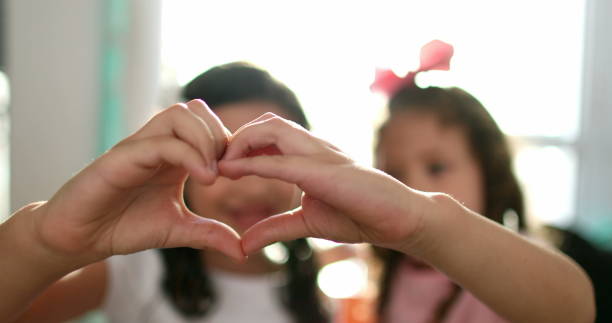 istock Children doing heart symbol with hands together close-up 1379161994