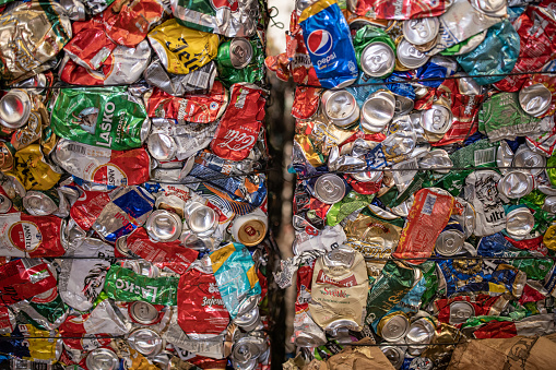 At the recycling center, cans are collected and packed for recycling