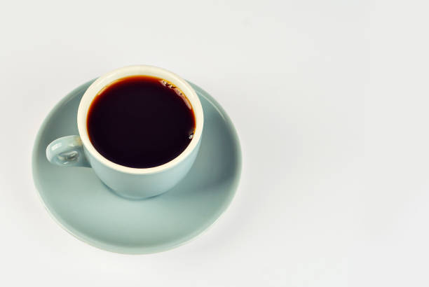 istock Ceramic blue coffee mug close up. Coffee isolated on a white background. Copy space and free space for text near the drink. 1379162183