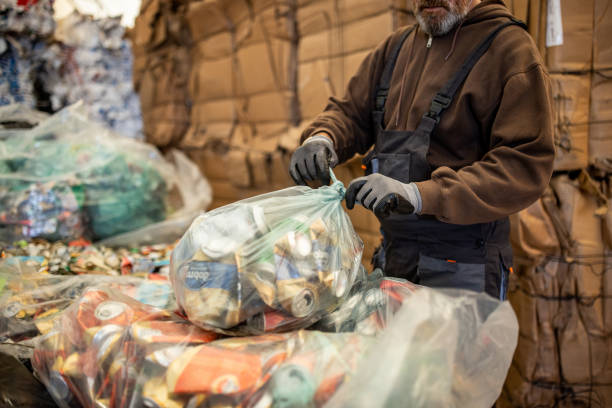 istock Unrecognizable worker packing and separates cans and bottles for recycling 1379162472