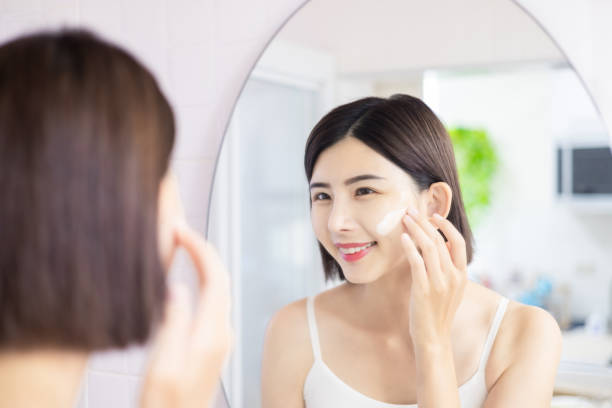 istock woman apply cream on face 1379163042