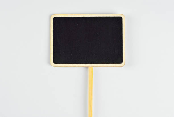 istock Isolated black wooden board for inscriptions on a white background. Product information panel. Price list or sign for product advertising. Free space for text and copy space on black board. 1379163073