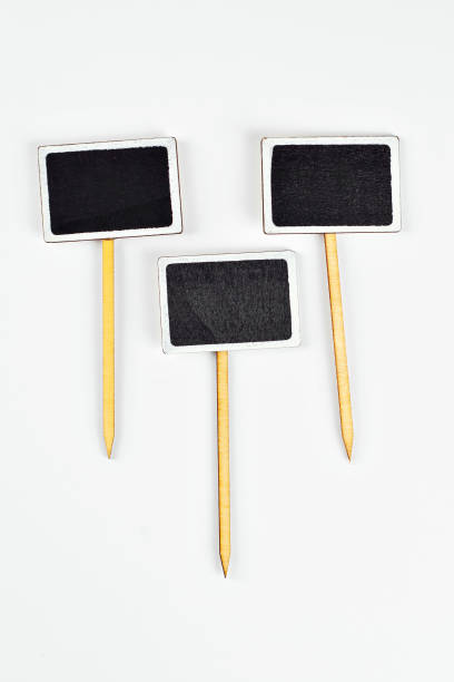 istock Isolated black wooden board for inscriptions on a white background. Product information panel. Price list or sign for product advertising. Free space for text and copy space on black board. 1379163075