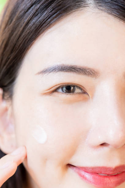 istock woman apply cream on face 1379163143