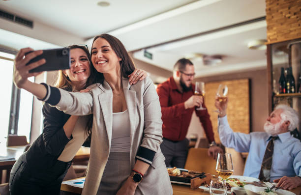 istock businesspeople taking a selfie together in a restaurant 1379163267
