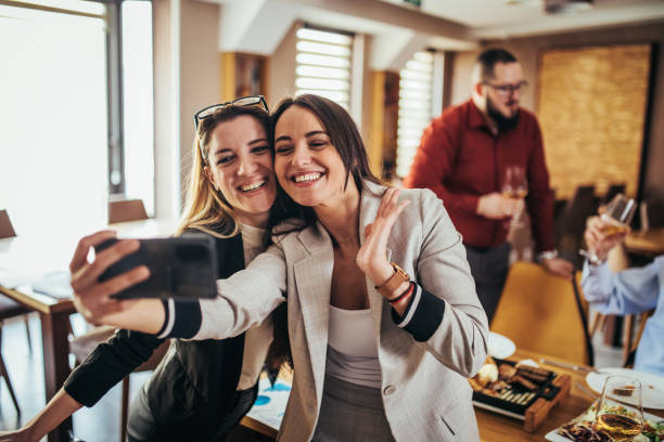 istock businesspeople taking a selfie together in a restaurant 1379163270