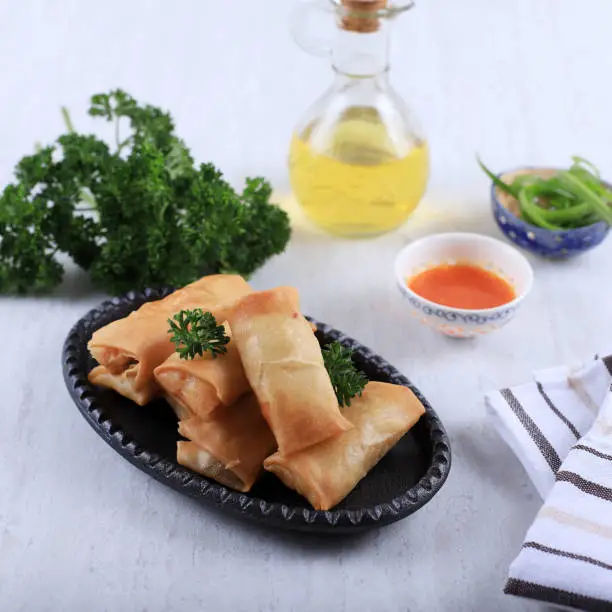 Homemade Spring Roll (Lumpia), Stuffed with Chicken and Shrimp, Served with Sour and Sweet Sauce, on White Table