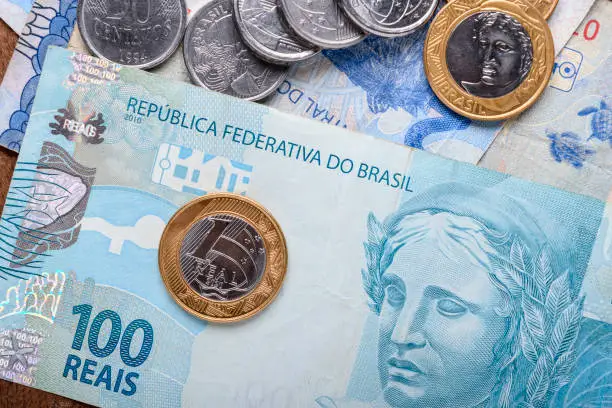 Photo of Brazilian money banknote and coins, economic market symbol, finance