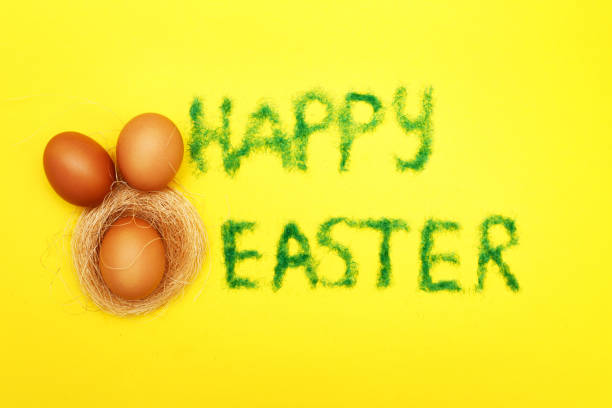 istock inscription happy easter from grass with bunny eggs and nest on yellow background 1379170386