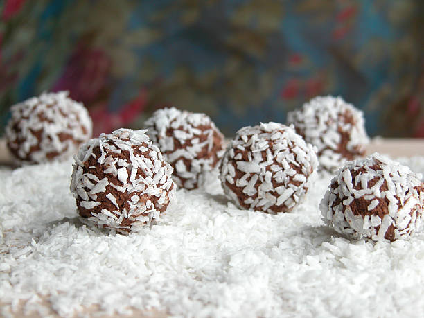 A ball of chocolates covered in coconuts