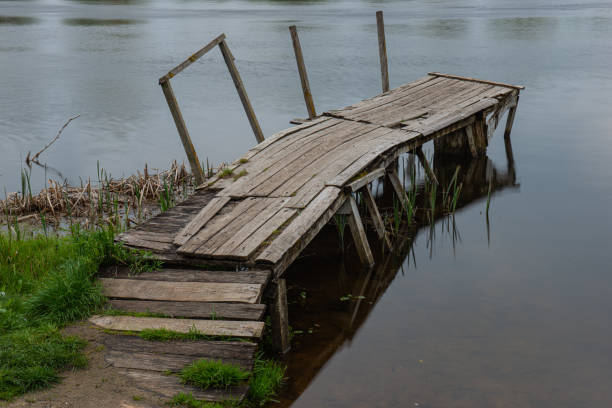 istock Old crumbling pier on the river bank. Early spring, April. 1379218593