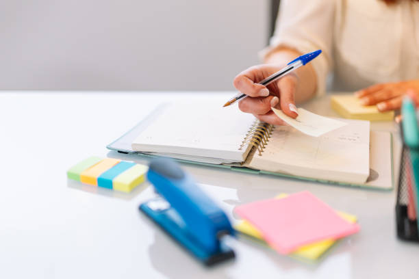 istock Hand of a young woman writing in a notebook 1379220781