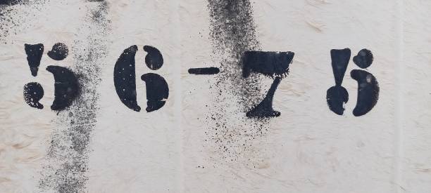istock fifty-six and seventy-five, number painted stencil on white backdrop 1379223391