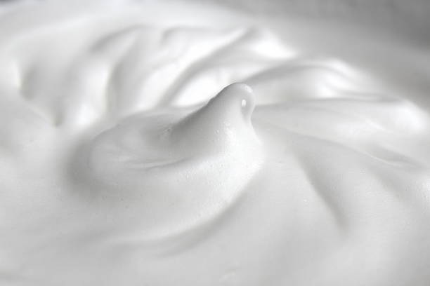 The texture of egg whites whipped into a large foam The texture of egg whites whipped into a large foam milk froth stock pictures, royalty-free photos & images