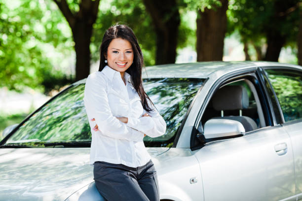 istock Woman cheering with her new car 1379235625